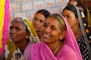 Image Credit: Flickr / mckaysavage. A member of the Gulabi Gang smiling during a meeting