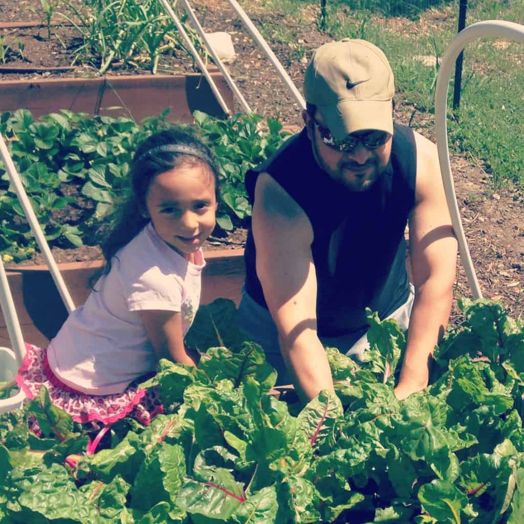 Tom and his daughter, Laila, in their organic garden. Credit: Tom Arguello
