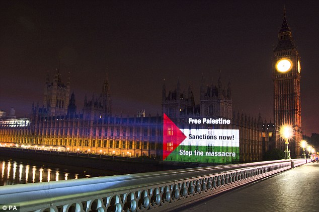 Stunt: A Palestinian flag calling for ‘Sanctions now’ was projected onto the Houses of Parliament.