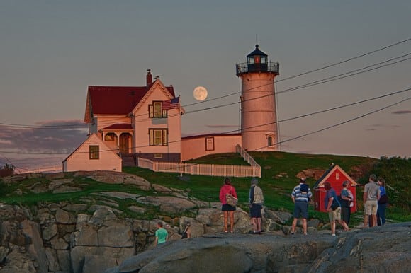 People watch the nearly ‘super’ Moon rise on August 9, 2014 near a lighthouse. Credit and copyright: Will Nourse.