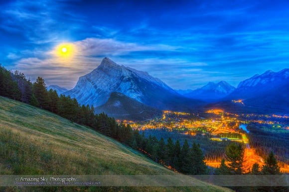 The supermoon of August 10, 2014 rising behind Mt. Rundle and Banff, Alberta, Canada as shot from the Mt. Norquay viewpoint looking south over the valley. Credit and copyright: Alan Dyer.