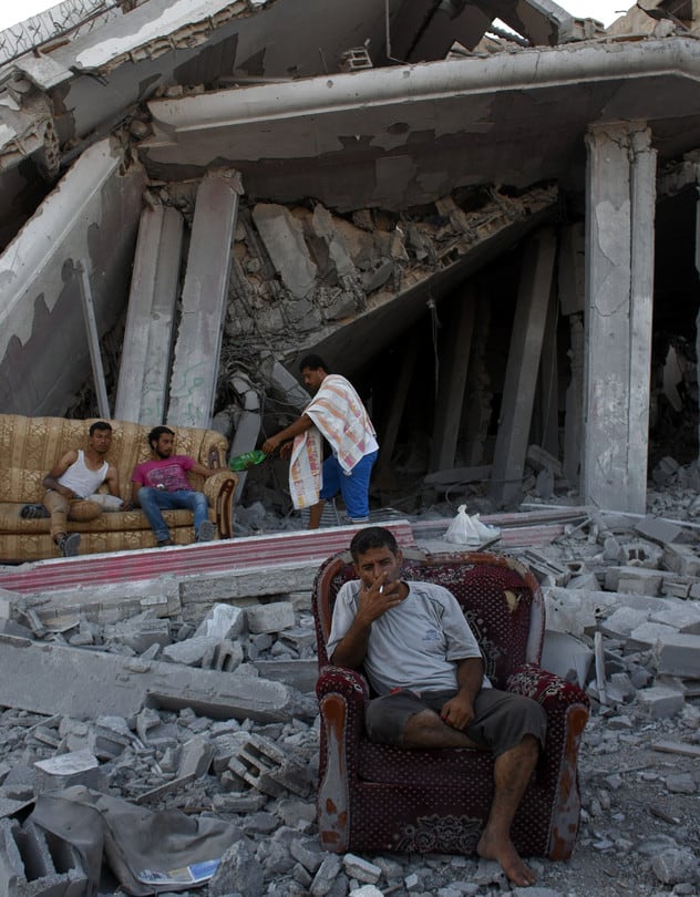 Displaced Palestinians sit amid the rubble of destroyed homes in Gaza on Tuesday. Heidi Levine/Sipa Press