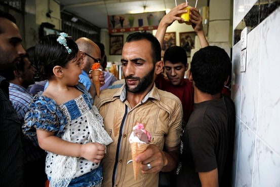 Palestinians crowd into an ice cream shop during the first day of a three day ceasefire in Gaza City on Tuesday. Finbarr O'Reilly/Reuters
