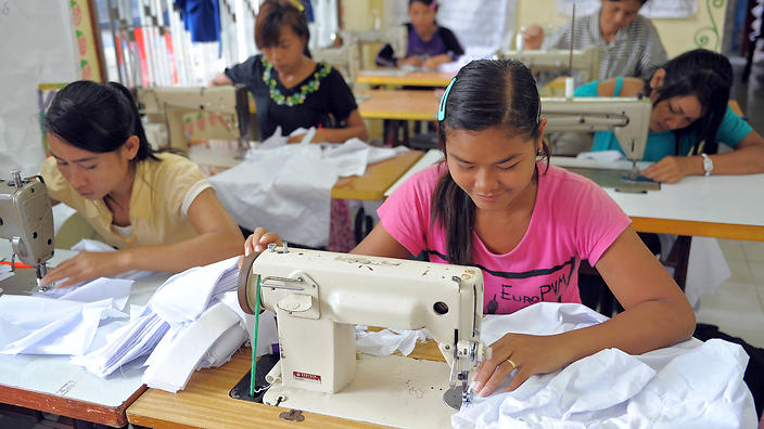 Cambodian female workers sew at a factory in Sihanouk province, some 230 kilometers southwest of Phnom Penh on September 9, 2009. Credit: SBS.com 