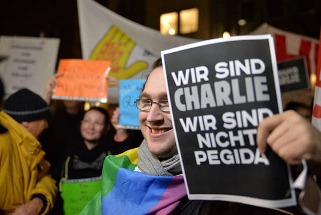 An anti-fascist protester holds a sign referring to French victims of terrorism, which says: "We are Charlie. We are not Pediga [a German far-right movement]." Credit: CC Flickr, Bündnis 90