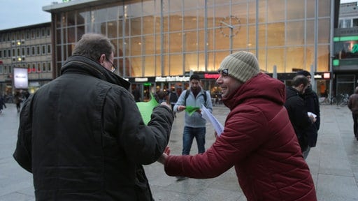 A Syrian refugee hands out leaflets condemning the assaults in Cologne. Credit: Syrians Against Sexism.