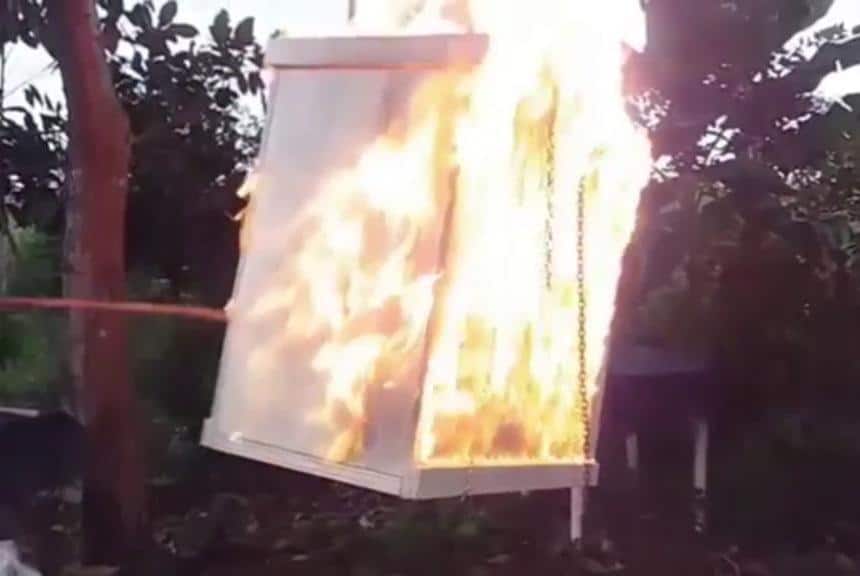 Environmental Activist Chains Himself Inside Flaming Box with Snake