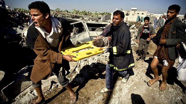 People carry the body of a child they uncovered from under the rubble of houses destroyed by Saudi airstrikes near Sanaa Airport, Yemen, Thursday, March 26, 2015. Saudi Arabia launched airstrikes Thursday targeting military installations in Yemen held by Shiite rebels who were taking over a key port city in the country's south and had driven the embattled president to flee by sea, security officials said. (AP Photo/Hani Mohammed)