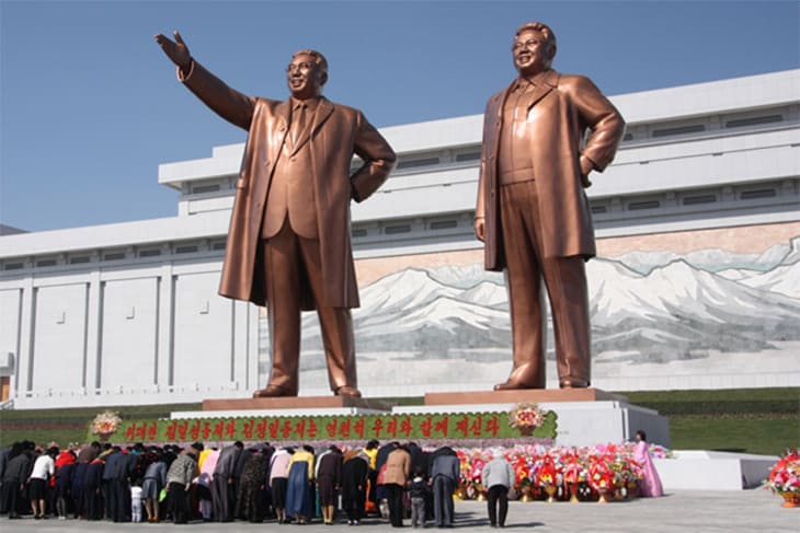 North Koreans bowing in front of statues of Kim Il-sung (left) and Kim Jong-il J.A. de Roo