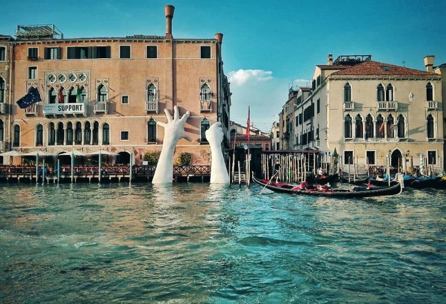 Giant Hands Rising From Venice Canals Send Important Message About Climate Change