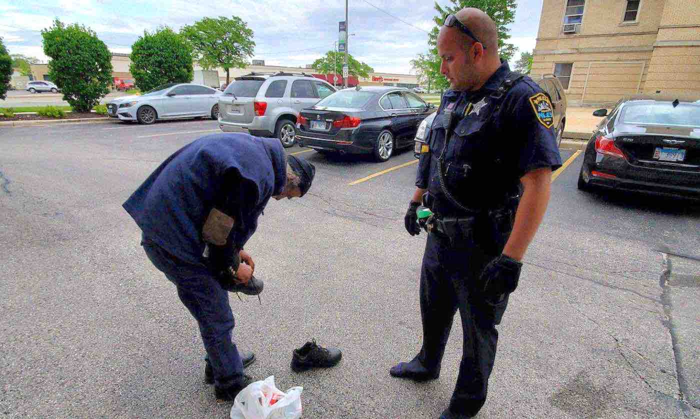 Homeless Man Wearing Worn-Out Shoes Trips Because Of Them, Policeman Notices And Hands Him His Own Shoes